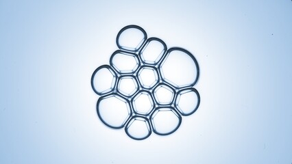 Bubble cluster of small clear bubbles on pale blue background | Shot of skincare gel ingredients for anti-aging concept