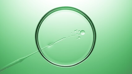 Top view macro shot of chemical dropper injects oil into clear liquid in petri dish on green...
