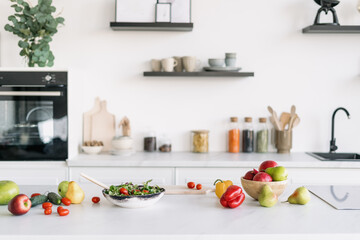 Variety of fruit and vegetables on table in kitchen