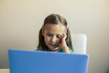 Little cute girl uses laptop to have video call