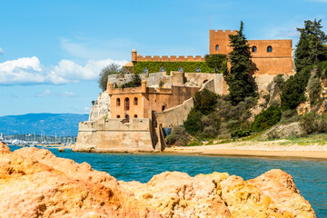 Coastline with sandy beach and castle in Ferragudo, Algarve, Portugal