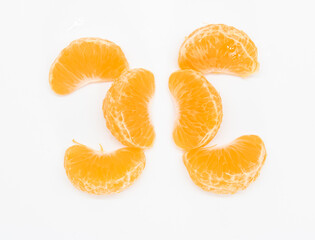 some slices of tangerine or komola isolated on white background, top view