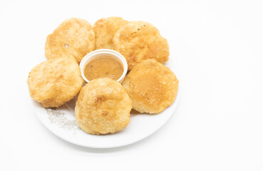 Puffed fried puri isolated on a white background.