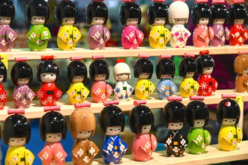 collection of Japanese dolls inspired by the tradition of mini kokeshi dolls narrow focus field