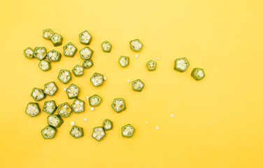 okra or Lady Finger pieces over on yellow background