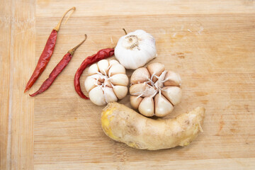 garlic with ginger and chili isolated on wooden background