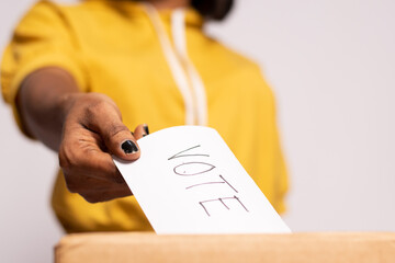 a black woman casting her vote