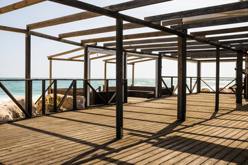 Wooden beachfront terrace at sunny day, Algarve, Portugal