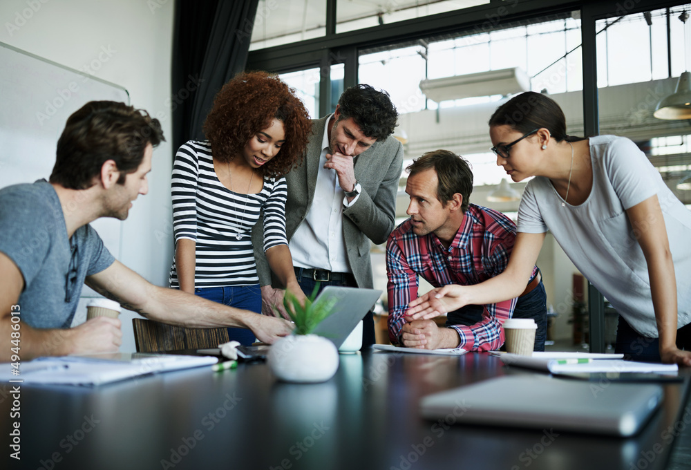 Poster theres a lot of brains on this project. shot of a group of coworkers talking around a laptop in a bo