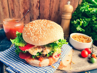  hamburger with salad and cheese and wooden 