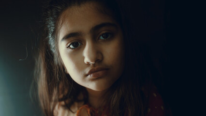 little girl doing homework in the dark