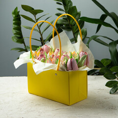 basket with marshmallows in the form of flowers. floral sweet decoration, marshmallow roses. sweet decoration, yellow basket in which nitri tulips from dessert