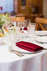 beautifully set tables with glasses and appliances for a wedding or other event