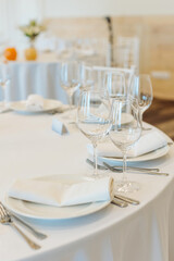beautifully set tables with glasses and appliances for a wedding or other event