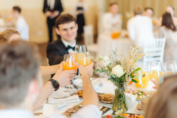 Clink glasses at a wedding or other event