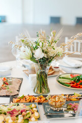 beautifully set tables with glasses and appliances for a wedding or other event
