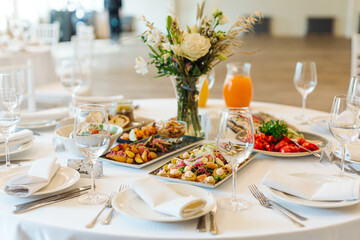 beautifully set tables with glasses and appliances for a wedding or other event
