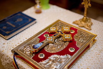 Closeup shot of a decorative red Bible with a gold cross in a church