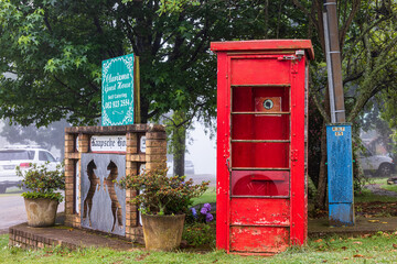 Old red phone booth in a park