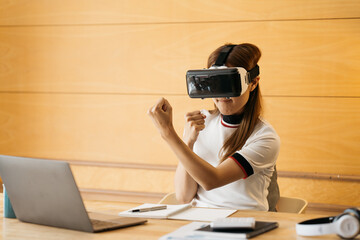 Woman wearing virtual reality goggles standing in a office. VR glasses. 360 degrees. Virtual reality headset. VR game. Wearing virtual reality goggles. Smartphone with VR. Virtual reality video.