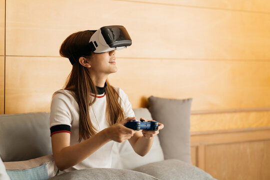 Virtual reality interaction headset by Asian Beautiful young female wearing touching air during VR box for playing game simulator future media. Technology digital Futuristic innovation device concept