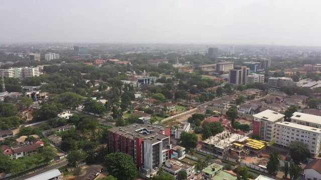 Aerial Accra Ghana urban neighborhood homes temple 4K. West Africa on the Atlantic ocean. Summer residential area with dirt streets, homes, houses, apartments and business. Crowded neighborhood.