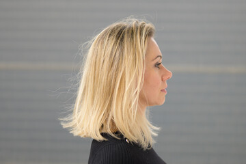 Profile portrait of a middle-aged woman with long blond hair