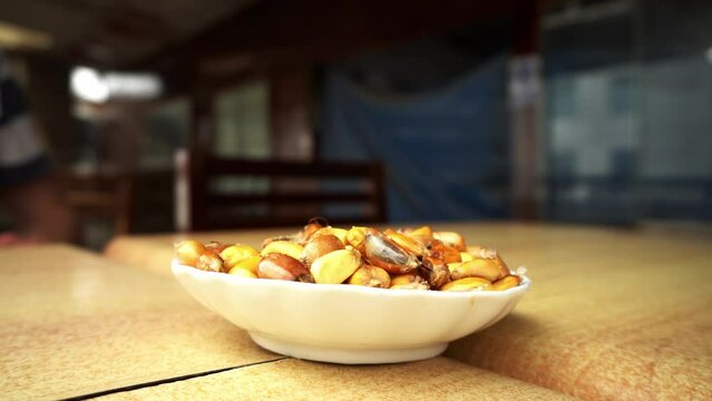 closeup of a plate of serrano popcorn canchita in a restaurant before they bring the main dishes that day in 4k