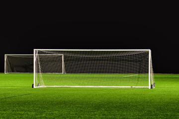 Soccer field with gates and with black on the background