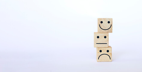 Obraz premium wooden cube stacked with emotion face icon on a white background rating increase rating excellent service Business Service Assessment customer experience Satisfaction Survey Concept