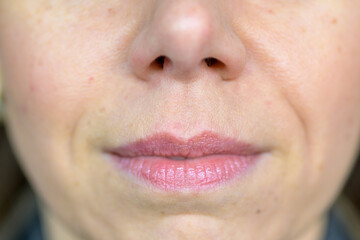Close up detail if the nose and mouth of a woman