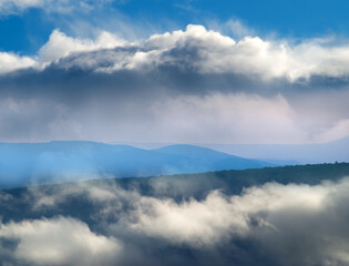 Naklejka premium Mountain peaks among the clouds.