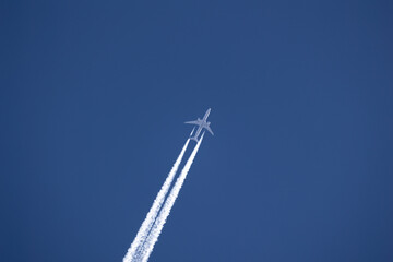 airplane in flight leaving a smokey trail
