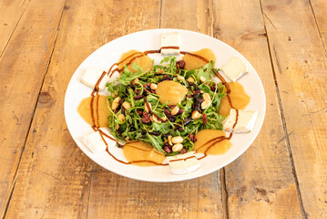 Great salad with pine nuts, brie cheese, raisins, arugula and balsamic vinegar