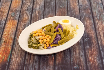 Vegetables from the garden cooked with oil and salt. Boiled egg, beans, chickpeas, cabbage and Swiss chard