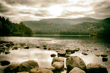 Peaceful scene with boulders scattered on the lakeshore