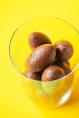 Chocolate Easter eggs in a glass. Easter background concept.