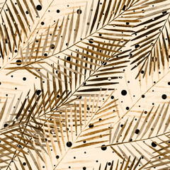 Seamless tropical pattern with palm leaves. Golden, brown palm leaves on a light beige background with polka dots.