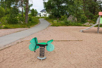 Beautiful landscape view of outdoor playground with swings. Sweden.