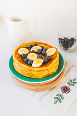 Pancakes with fresh blueberries, banana and honey