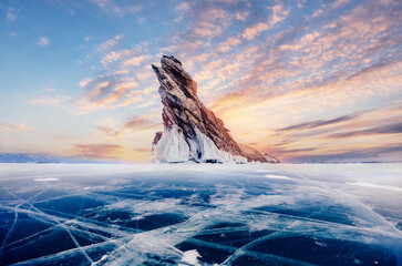 Beautiful landscape island Ogoy winter lake Baikal with transparent cracked blue ice. Concept travel Russia
