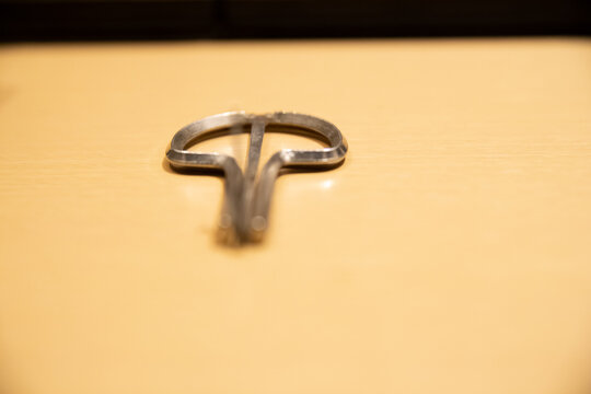 Closeup Of A Small Metal Jaw Harp On A Wooden Surface