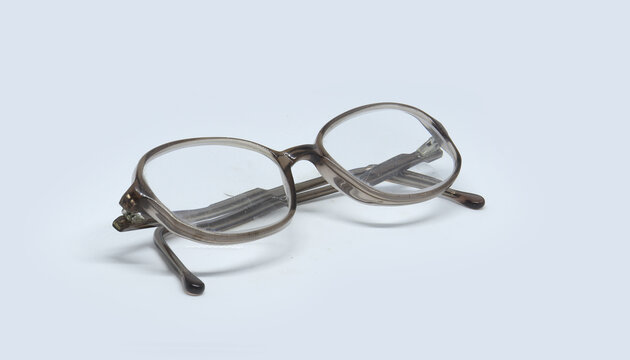 Pair Of Gray Folded Eyeglasses Isolated On A White Background