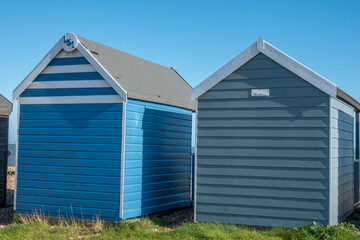 Fototapeta na wymiar blue beach huts on the beach at Calshot Hampshire England