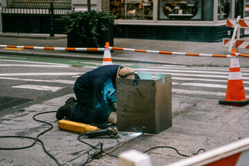 Closeup of the welder working on the street.