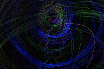 Light painting Abstract colorful irregular lines or patterns on black background with long exposure.