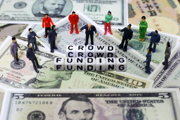 crowd of people and letter cube on dollar background. conceptual image of crowd funding for start-up business, raised fund, invesment or donation.