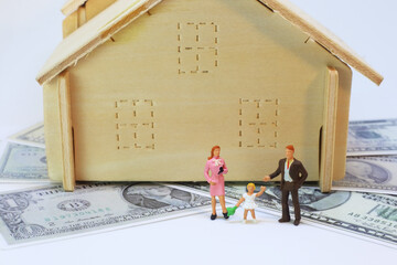 Family and house on dollar background. conceptual image of mortgage housing.