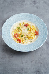 Tagliatelle pasta with different types of cheeses