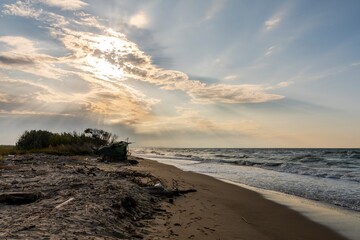 Decaying seascape with litter abandoned on the beach